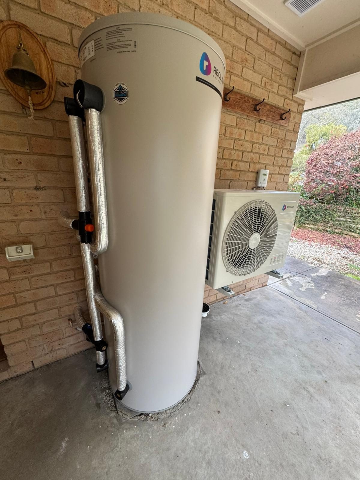 Heat pump hot water system installed outside a home